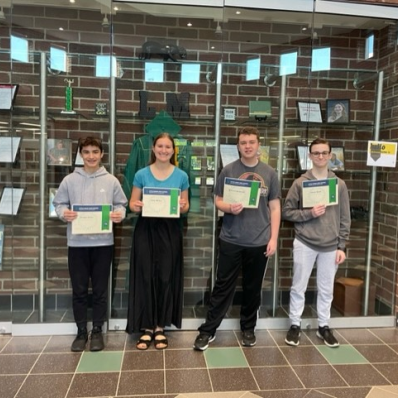 students smiling holding certificate